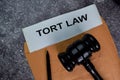 Tort Law text write on a paperwork and gavel isolated on office desk