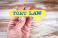 Tort Law. Yellow speech bubble in a man& x27;s hand