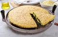 Torta al testo, Italian recipe from Umbria. Corn focaccia with chicory and cheese in cast iron skillet.