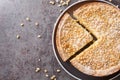 Torta della Nonna a soft flat italian cake flavoured with pine nuts closeup in the plate. Horizontal top view