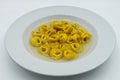 Tortellini in brodo tortellini in broth in a white dish. Traditional italian cuisine. Royalty Free Stock Photo