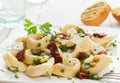 Tortellini with feta, basil, pine nuts and tomato Royalty Free Stock Photo