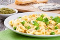 Tortellini with green peas, fried Pine nuts, top view