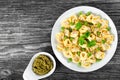 Tortellini with green peas, fried Pine nuts, top view