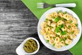 Tortellini with green peas, fried Pine nuts, top view