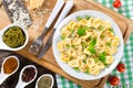 Tortellini with green peas, fried Pine nuts, top view