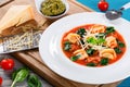 Tortellini soup with italian sausages, spinach, tomato, parmesan cheese , pesto-sauce Royalty Free Stock Photo