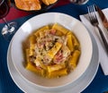 Tortiglioni in carbonara cheese sauce with cured meat guanciale