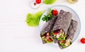 Tortilla with added ink cuttlefish wraps with chicken and vegetables on white background Royalty Free Stock Photo