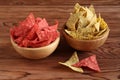 Tortilla chips with chia seeds and tortilla chips with beetroot in bamboo bowls on wooden table. Royalty Free Stock Photo