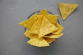 Tortilla chips in glass bowl over concrete surface, top view. Mexican food. From above, overhead