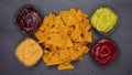 Tortilla chips piling up between sauce bowls - stop motion