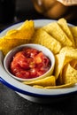 Tortilla chips and red tomato salsa dip. Mexican nacho chips Royalty Free Stock Photo