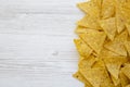 Tortilla chips on white wooden table, top view. Mexican food Royalty Free Stock Photo