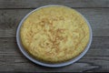 Tortilla de patatas or Spanish potato omelette on a white plate on wooden rustic background.Delicious spanish cuisine tapas Royalty Free Stock Photo