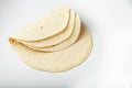 Tortilla on a white isolated background. Corn tortilla or simply tortilla is a type of thin unleavened bread made from Hominy