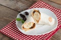 Tortilla wrap with peanut butter, raisin and banana on whi