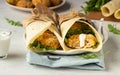 Tortilla wraps with chicken or turkey cutlets, arugula and sour cream sauce Royalty Free Stock Photo