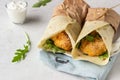 Tortilla wraps with chicken or turkey cutlets, arugula and sour cream sauce Royalty Free Stock Photo