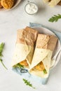 Tortilla wraps with chicken or turkey cutlets, arugula and sour cream sauce Royalty Free Stock Photo