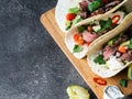 Tortillas with vegetables and beef steak slices. Avocados, tomatoes, red onions and meet with cilantro and lime juice in tortillas Royalty Free Stock Photo