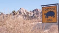 Tortoise or turtle crossing yellow road sign, California USA. Wild animal xing. Royalty Free Stock Photo