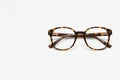 Tortoiseshell glasses on a white background. Space for text. Royalty Free Stock Photo