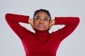 Tortured girl, Afro-American appearance, with displeased look looking up with hands over ears.