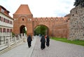 TORUN, POLAND. Catholic nuns walk through the grounds of the Old Town. Gdanisco Tower 14th century Royalty Free Stock Photo