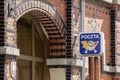 Logo of POCZTA Post Office in Polish on historic red brick building