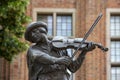 Statue of a raftsman playing the fiddle surrounded by frogs, Torun, Poland