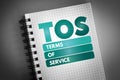 TOS - Terms Of Service acronym on notepad, concept background