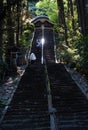 O-henro pilgrims climbing the steep stairs leading to the main hall of Shoryuji, Royalty Free Stock Photo