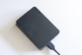 Toshiba external hard drive plugged into computer via usb cable on white background Royalty Free Stock Photo