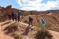 Tourists walk around Fairytale canyon or Skazka Canyon, Natural park of colorful rocks near Issyk-Kul lake, Kyrgyzstan.