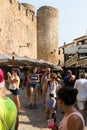 Tossa de Mar, Catalonia, Spain, August 2018. Shopping street near the walls of the old fortress and walking tourists.