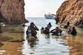 Tossa de Mar, Spain, August 2018. A group of scuba divers in a small bay among the rocks.