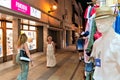 Tossa de Mar, Spain, August 2018. Mannequin on a shopping street and people passing by.