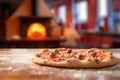 tossed pizza dough with a blurred brick oven background
