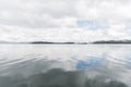 Tota lake, calm landscape, cloudy sky reflected in the water surface