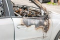 Total damage on new expensive burned car in fire on the parking lot, selective focus