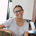 Total job satisfaction. Portrait of a smiling young office worker sitting in a boardroom. Royalty Free Stock Photo