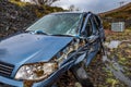 Total loss car with broken windscreen, axle fracture and police barrier band Royalty Free Stock Photo