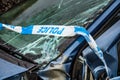 Total loss car with broken windscreen, axle fracture and police barrier band Royalty Free Stock Photo