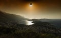 Total solar eclipse in dark red glowing sky above seaside city