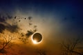 Total solar eclipse in dark red glowing sky