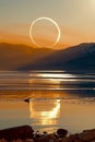 Total solar eclipse event over a lake with reflection.