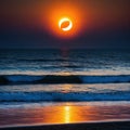 A total solar eclipse with the sun just above the view from the beach at sunset Royalty Free Stock Photo