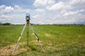 total station in the field survey equipment in a green land being measured