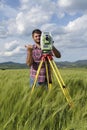 Total station Wheat field Engineer Surveyor Royalty Free Stock Photo